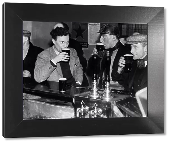 Miners enjoying a drink after work. 4th February 1947