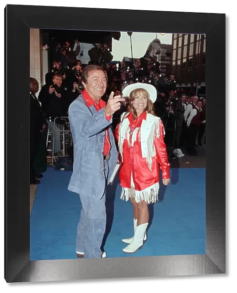 Des O Connor and guest arriving at Elton Johns 50th birthday party at