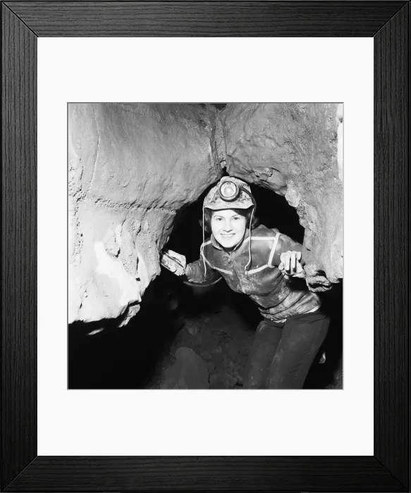 Framed Print : Eillen Davies seen here making her way thorough a series of caves under the Brecon Framed Print : Eillen Davies seen here making her way thorough a series of caves under the Brecon