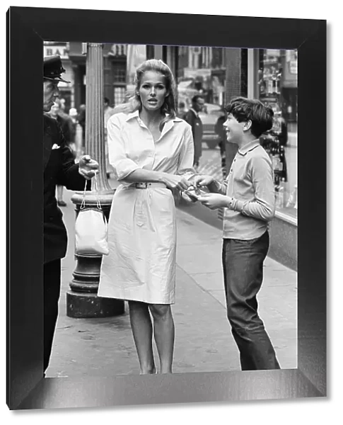 Ursula Andress, Swiss actress, signs autograph for young admirer