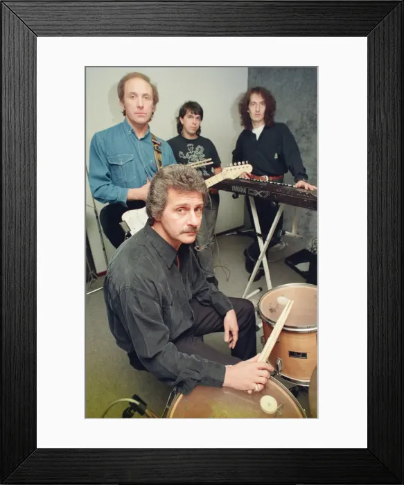 Framed Print : Pete Best, (in the black shirt holding his drum sticks) posing for the camera with his Framed Print : Pete Best, (in the black shirt holding his drum sticks) posing for the camera with his