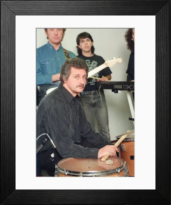 Framed Print : Pete Best, (in the black shirt holding his drum sticks) posing for the camera with his Framed Print : Pete Best, (in the black shirt holding his drum sticks) posing for the camera with his