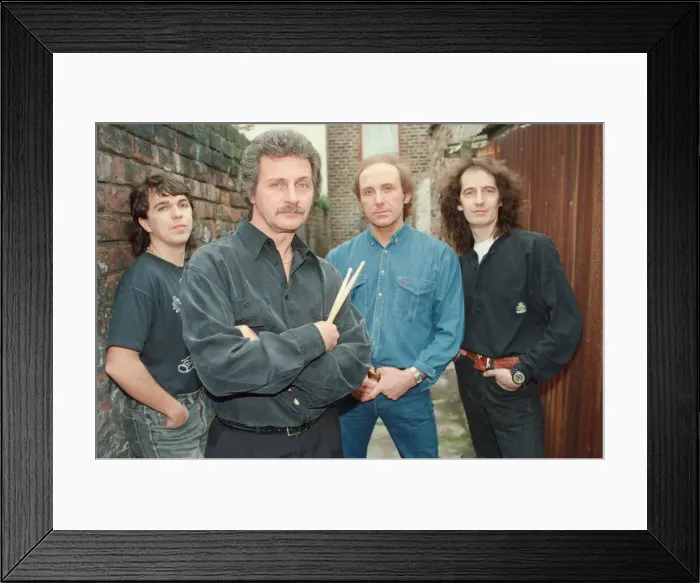 Framed Print : Pete Best, (in the black shirt holding his drum sticks) posing for the camera with his Framed Print : Pete Best, (in the black shirt holding his drum sticks) posing for the camera with his