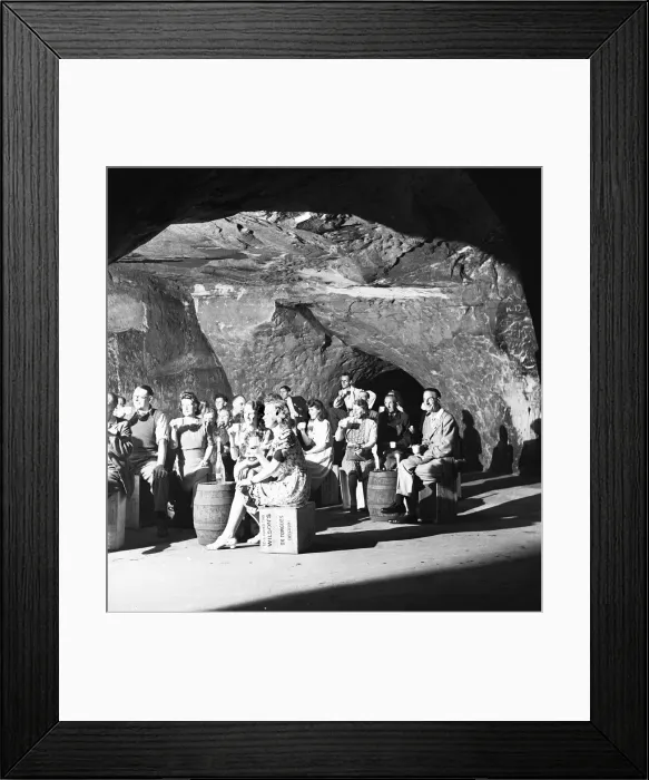 Framed Print : The audience of a performance of the Pirates of Penzance in the caves in the cliffs above Framed Print : The audience of a performance of the Pirates of Penzance in the caves in the cliffs above