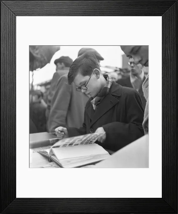 Framed Print : A young stamp collector looking to add to his collection at the flea market in Club Row Framed Print : A young stamp collector looking to add to his collection at the flea market in Club Row