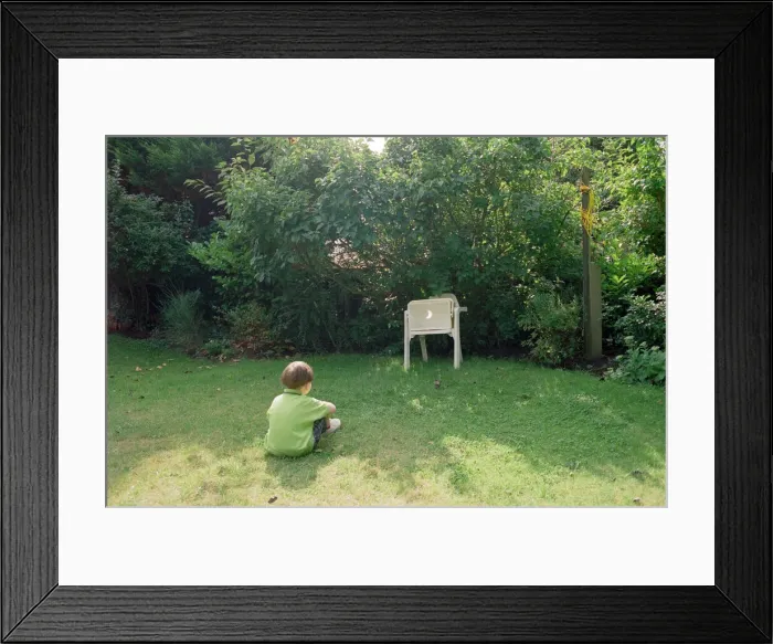 Framed Print : A child watching the solar eclipse indirectly at Hightown. 11th August 1999 Framed Print : A child watching the solar eclipse indirectly at Hightown. 11th August 1999