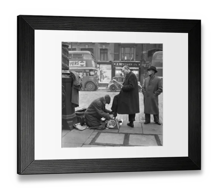 Framed Print : Shoe shine at work in Whitechapel High Street in the east end of London