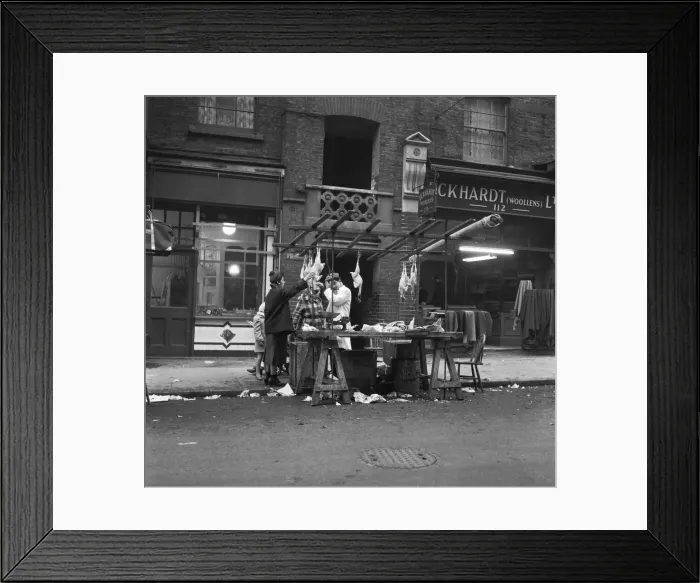 Framed Print : Women peruse kosher chickens at an un-named street market in the East End of London 11th