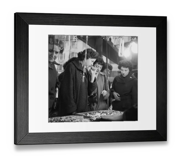 Framed Print : Women peruse the jewellery on a market stall at an un-named street market in the East End