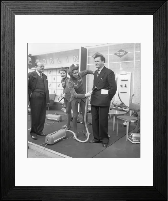 Framed Print : Ideal Home Exhibition Olympia. 3rd March 1955 A journalist is hoovered by a sales
