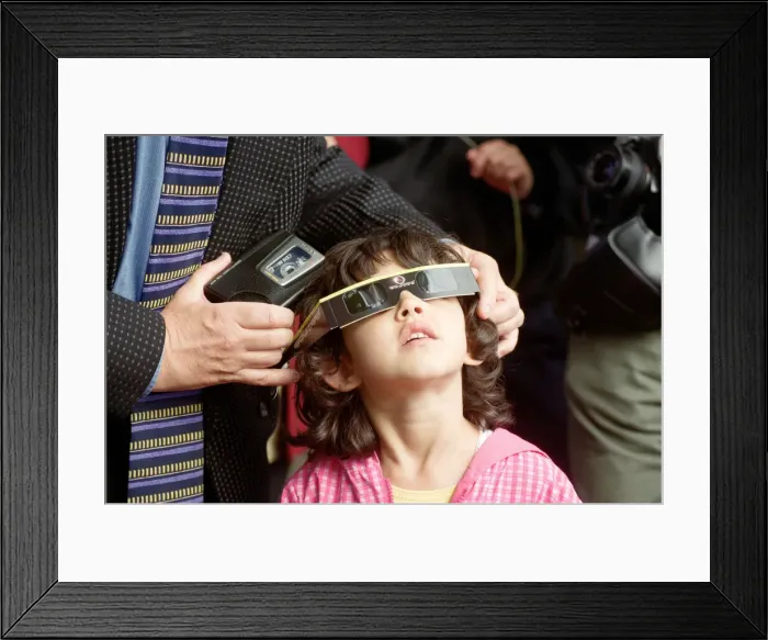 Framed Print : A young girl watching the solar eclipse in Chester. 11th August 1999 Framed Print : A young girl watching the solar eclipse in Chester. 11th August 1999