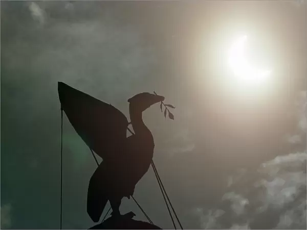 The solar eclipse pictured behind the Silhouette of the Liver Bird on a tower of