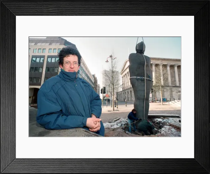 Framed Print : British sculptor Antony Gormley stands beside his latest work