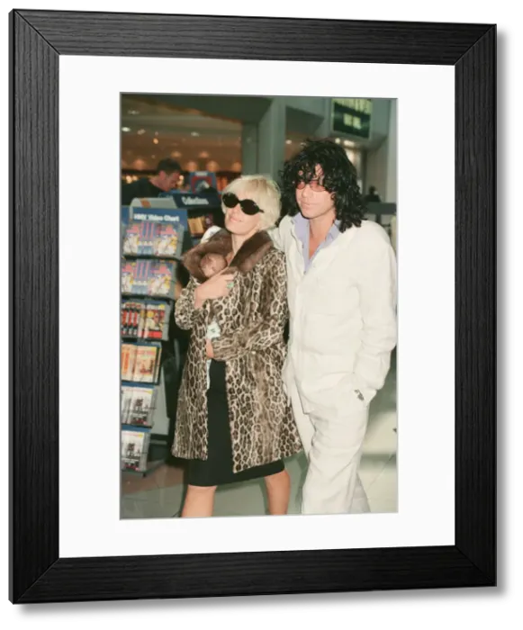Framed Print : Paula Yates and her boyfriend, INXS singer Michael Hutchence leave Heathrow Airport for