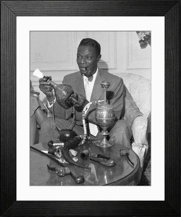 Framed Print : Singer and pipe collector Nat King Cole seen here with his collection of pipes in his Framed Print : Singer and pipe collector Nat King Cole seen here with his collection of pipes in his