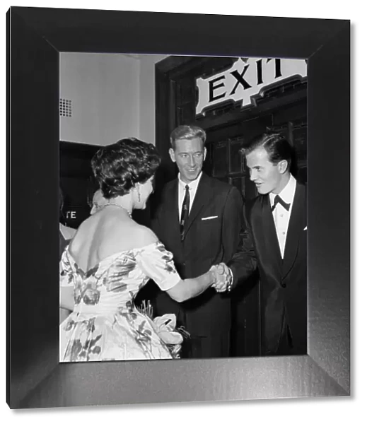Princess Margaret shakes hands with Pat Boone, in the middle is ventriloquist Ron Parry