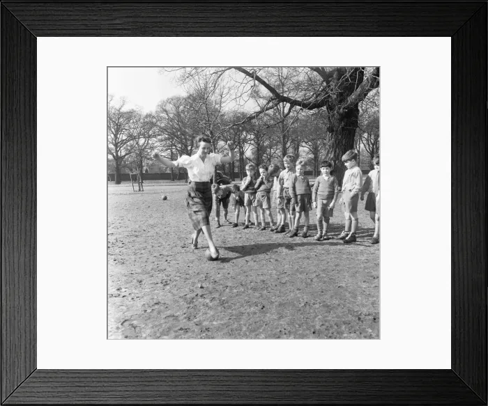 Framed Print : Sports mistress, Miss Reid, teaches football to the boys of Park Hill School, Kingston Framed Print : Sports mistress, Miss Reid, teaches football to the boys of Park Hill School, Kingston