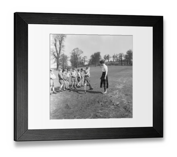 Framed Print : Sports mistress, Miss Reid, teaches football to the boys of Park Hill School, Kingston