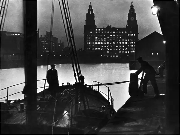 Scene at Princes Dock in Liverpool showing seamen unloading cargo from one of
