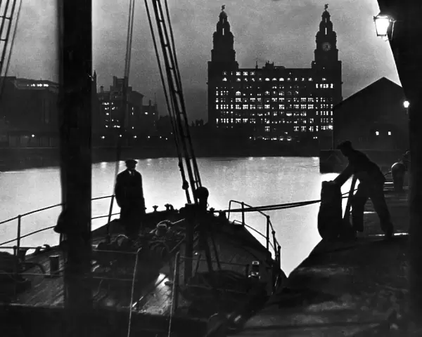 Scene at Princes Dock in Liverpool showing seamen unloading cargo from one of