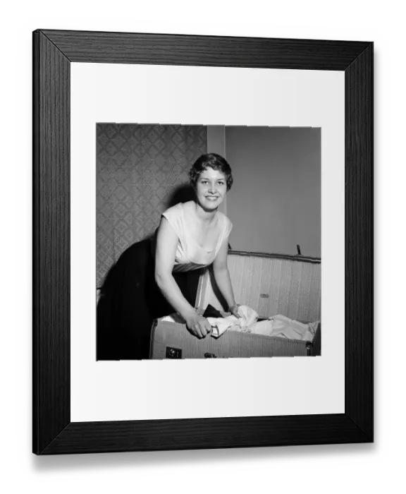 Framed Print : 21-year-old actress Anne Reid at home in Kensington packing her bags before leaving for