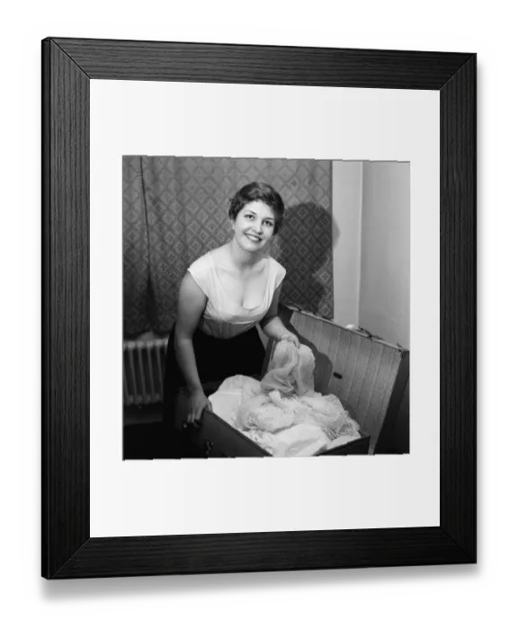 Framed Print : 21-year-old actress Anne Reid at home in Kensington packing her bags before leaving for