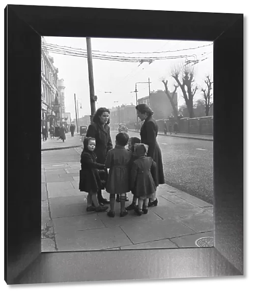 Mums and children gather on a corner of the Harrow Road close to the Regent Canal