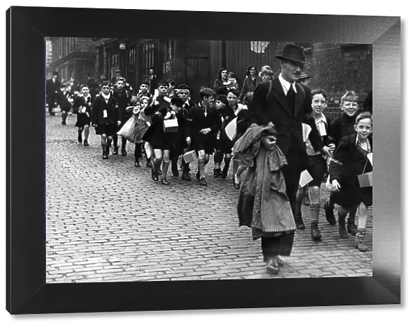Teachers accompany a large crowd of pupils of a liverpool inner city school to