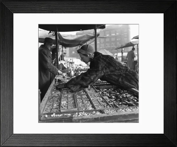 Framed Print : Housewife browsing the antique stalls of the New Caledonian Street Market for jewellery Framed Print : Housewife browsing the antique stalls of the New Caledonian Street Market for jewellery