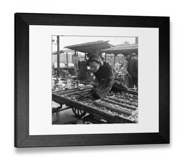 Framed Print : Housewife browsing the antique stalls of the New Caledonian Street Market for jewellery