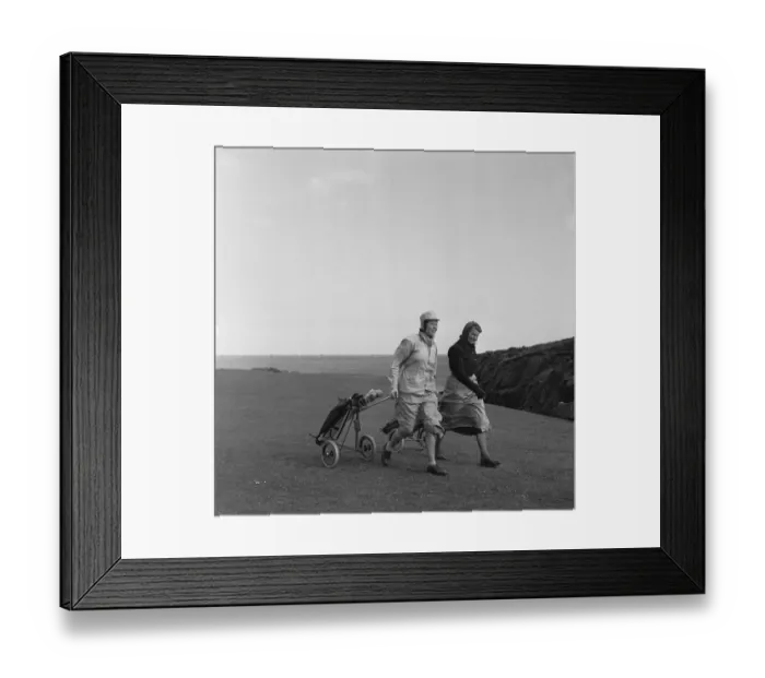 Framed Print : Women playing a round of golf on a very windy Fort Island Golf links Hotel on the Isle of Framed Print : Women playing a round of golf on a very windy Fort Island Golf links Hotel on the Isle of