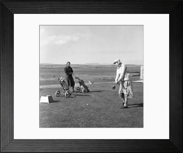 Framed Print : Women playing a round of golf on a very windy Fort Island Golf links Hotel on the Isle of Framed Print : Women playing a round of golf on a very windy Fort Island Golf links Hotel on the Isle of