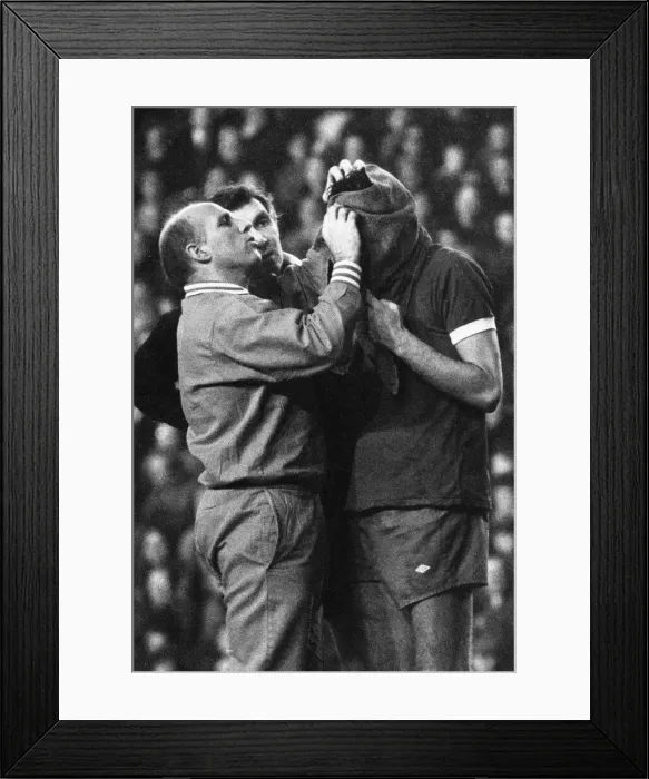 Framed Print : Liverpool trainer Ronnie Moran attends to John Toshack who has received a nasty cut