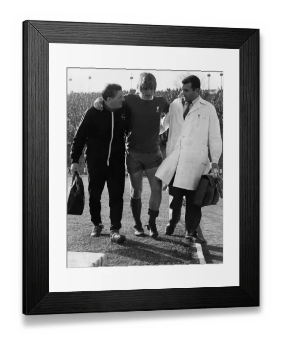 Framed Print : Injured Liverpool footballer Alun Evans helped off the pitch by Bob Paisley (left