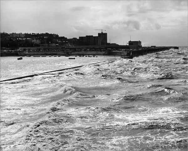 Stormy night ahead as an angry evening tide lashes the sea wall of Marine Lake in New