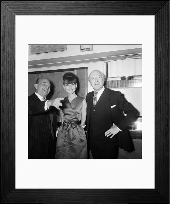 Framed Print : Actress Audrey Hepburn pictured with Jack L Warner (left Framed Print : Actress Audrey Hepburn pictured with Jack L Warner (left