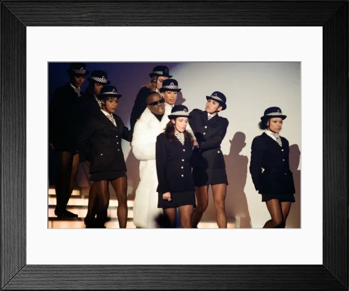 Framed Print : Mark Morrison flanked by dancers dressed as policewomen