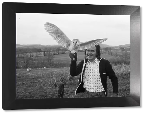 Ex-pop singer Billy Fury with a barn owl. The bird has been brought from his London home