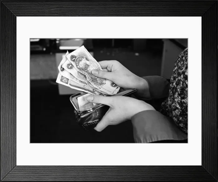 Framed Print : A purse filled with pound notes. 31st January 1977
