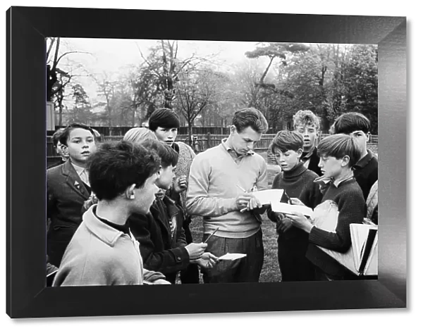 Injured Liverpool footballer Gordon Milne signs autographs for young fans as his