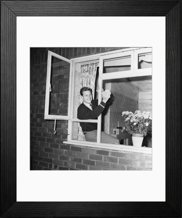 Framed Print : Liverpool footballer Gordon Milne, pictured at his home, cleaning the front windows Framed Print : Liverpool footballer Gordon Milne, pictured at his home, cleaning the front windows