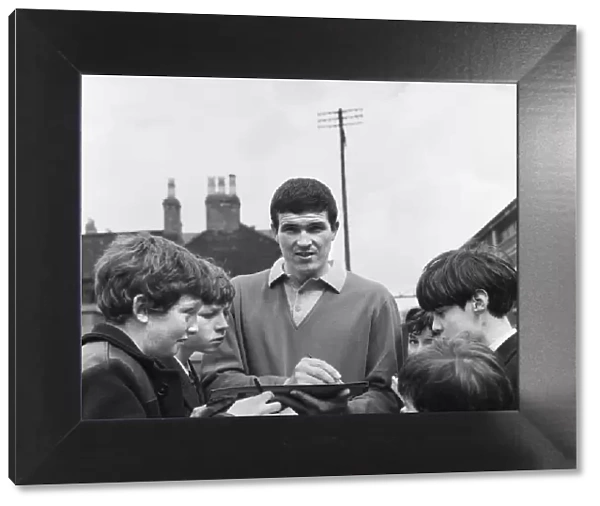 Liverpool footballer Ron Yeats signs autographs for young fans outside the Liverpool