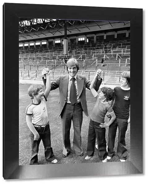 New Liverpool signing Kenny Dalglish with fans on the pitch at Anfield as he completes
