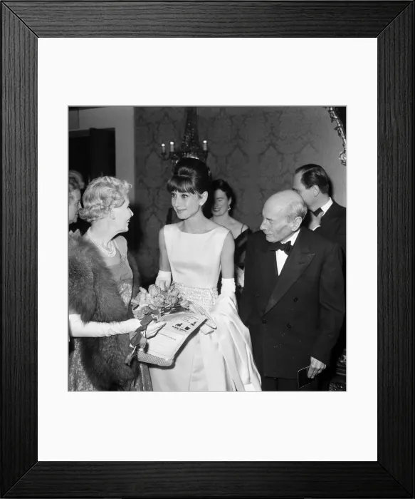 Framed Print : Actress Audrey Hepburn pictured with Earl and Countess Attlee at the London premiere of