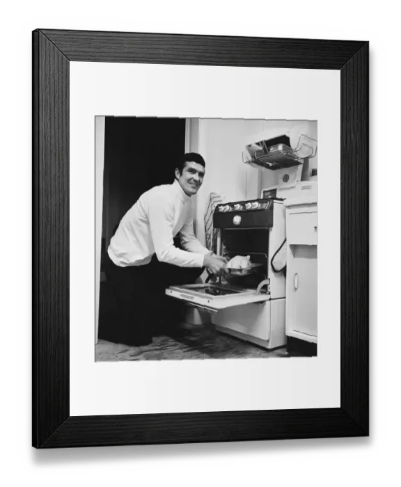 Framed Print : Liverpool footballer Ron Yeats poses at home with his new gas cooker