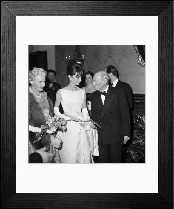 Framed Print : Actress Audrey Hepburn pictured with Earl and Countess Attlee at the London premiere of