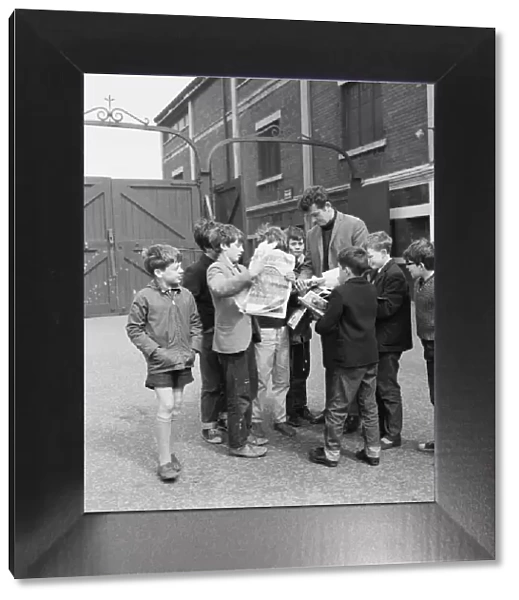 Liverpool goalkeeper Tommy Lawrence sign autographs for fans outside Anfield football