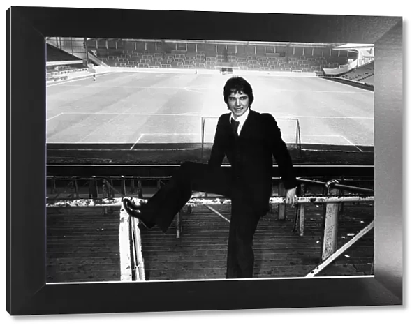 New Liverpool signing Alan Hansen poses at an empty Anfield stadium following his £