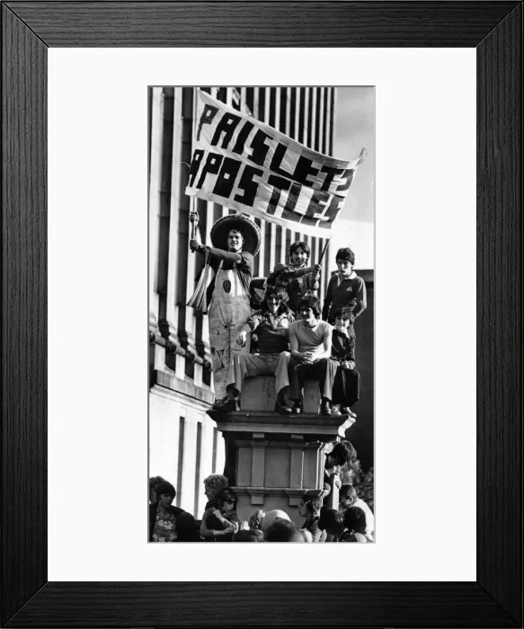 Framed Print : Liverpool fans carrying a Paisleys Apostles'banner as they gather with Framed Print : Liverpool fans carrying a Paisleys Apostles'banner as they gather with