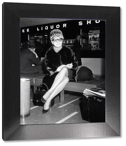Sophia Loren at London Airport, leaving for Paris where she will do some shopping prior